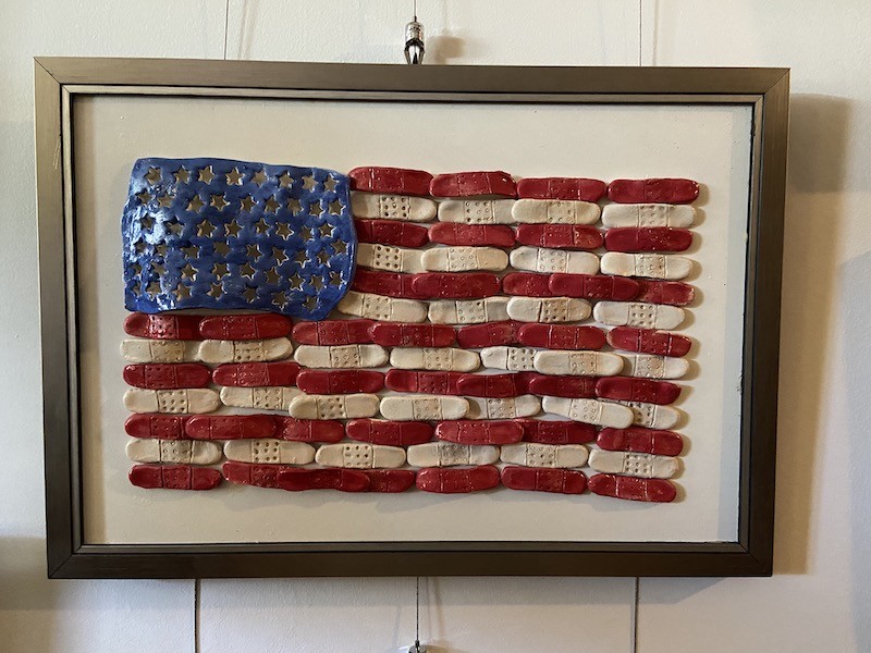 Artwork of American Flag made up of bandages hung on art hanging system