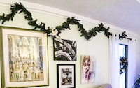 Living room decorated with holiday greens hung on picture hanging system