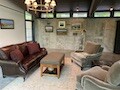 Art hung on concrete wall in living room using picture hanging system