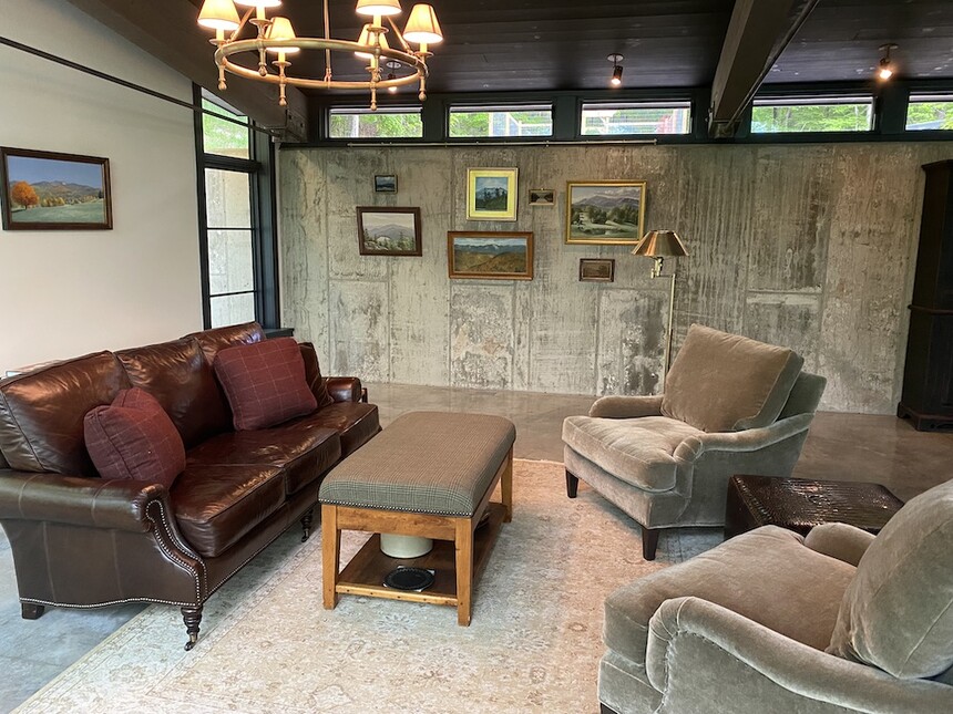 Art hung on concrete wall in living room using picture hanging system
