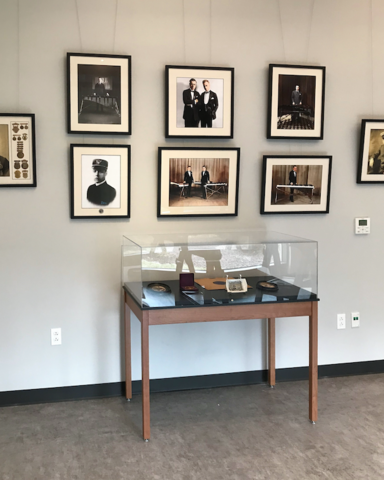 Display case and wall hangings at musical instrument museum with picture hanging system