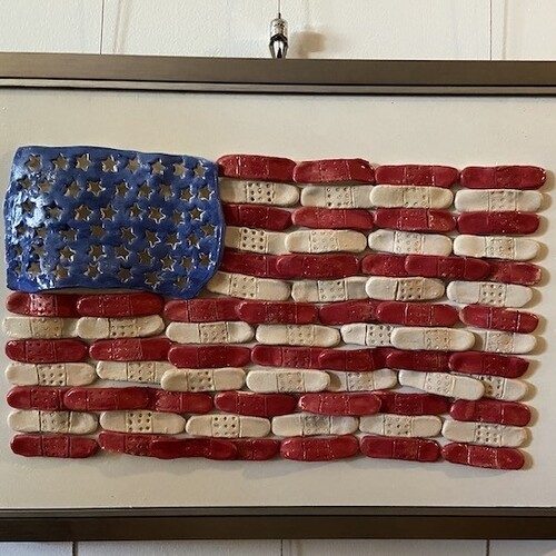 Artwork of American Flag made up of bandages hung on art hanging system